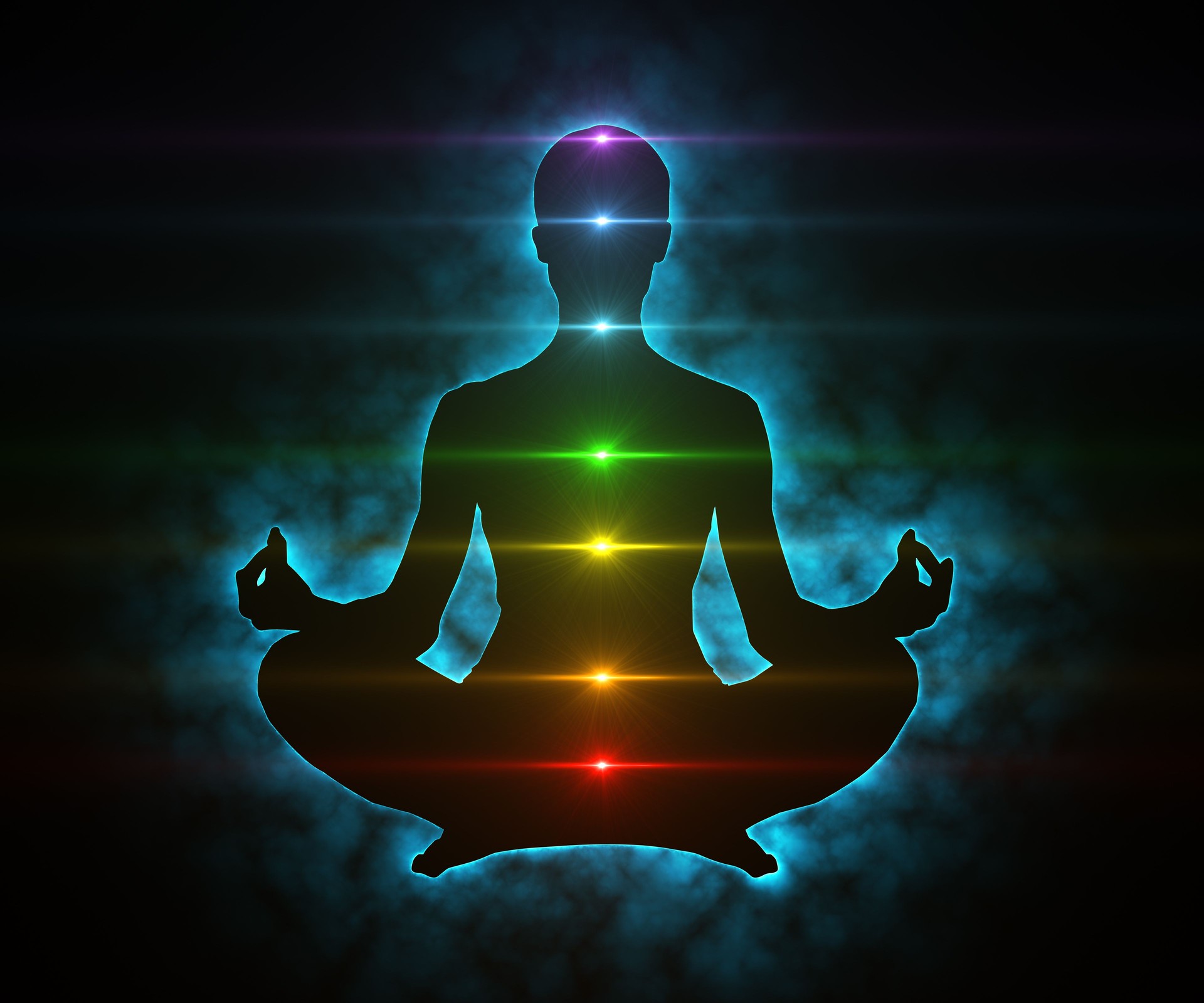 Meditating figure in lotus position with glowing colorful chakras